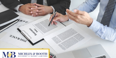 men looking over insurance policy