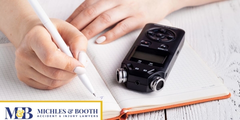 hands taking notes next to a recorder