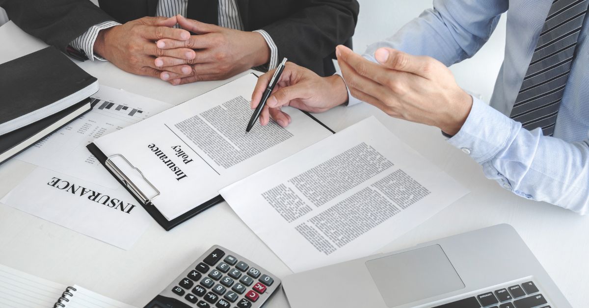 men looking over insurance policy