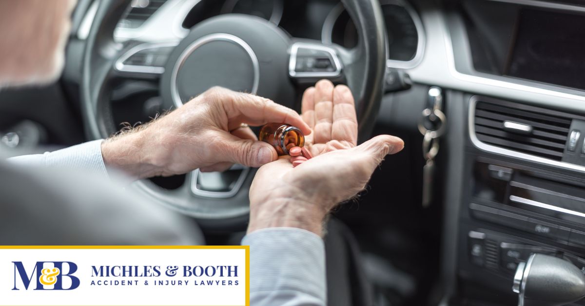 Car driver taking medication while behind the wheel.