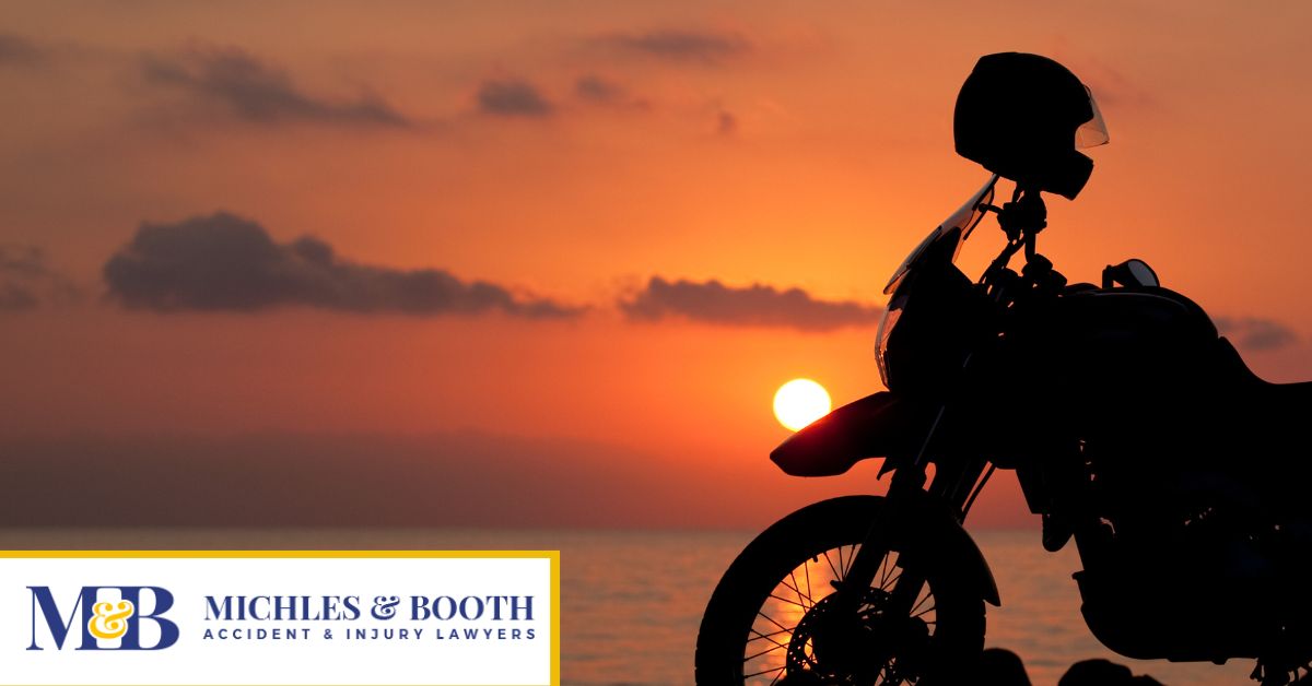 Silhouette of a motorcycle and a helmet with the sunset in the back
